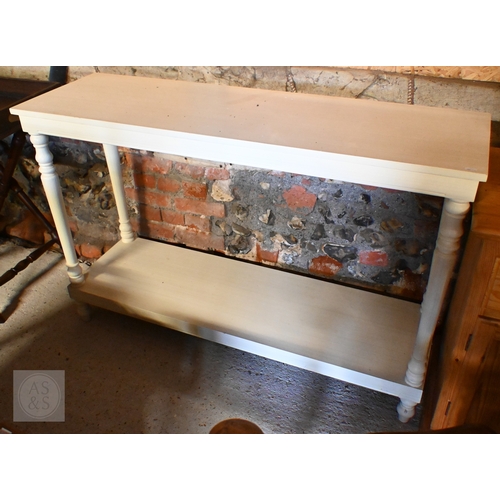 198 - A modern cream-painted two-tier console table with turned supports, 130 x 40 x 86 cm high