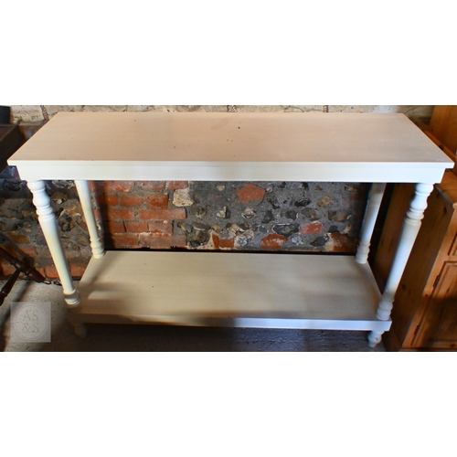 198 - A modern cream-painted two-tier console table with turned supports, 130 x 40 x 86 cm high