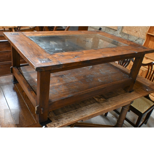 216 - A Lombok rustic-stained hardwood two-tier coffee table with inset glass top, 120 x 80 x 50 cm high