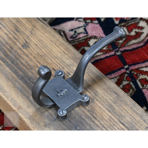 28 - A vintage style five hanger wall coat rack, the metal twin hooks numbered 1-5, 91 cm long