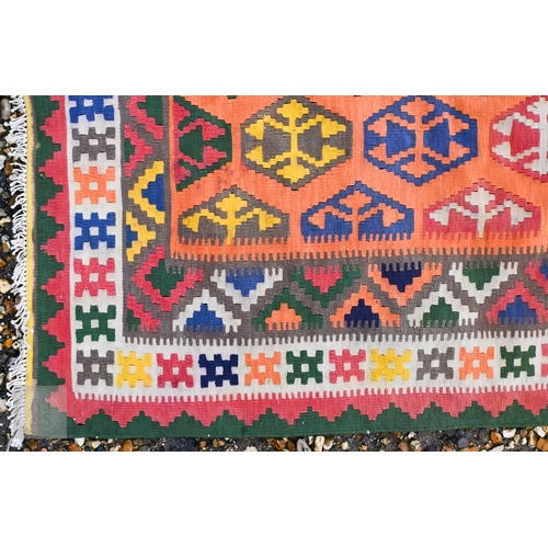 283 - A large orange ground South West Persian Qashqai kilim, geometric design with repeating hexagonal me... 