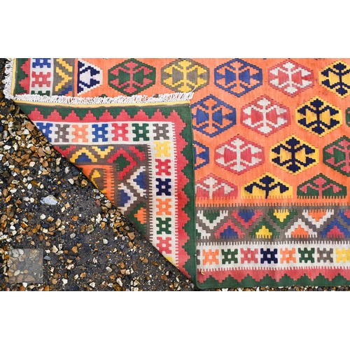 283 - A large orange ground South West Persian Qashqai kilim, geometric design with repeating hexagonal me... 