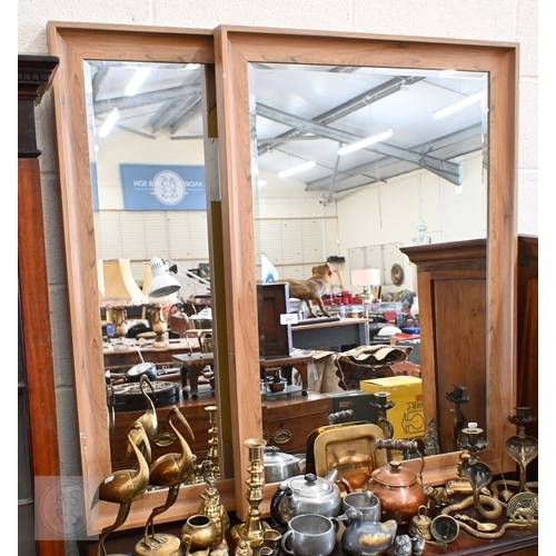 371 - A pair of modern bevelled mirrors in lightly stained moulded hardwood frames, 104 x 72 cm (2)
