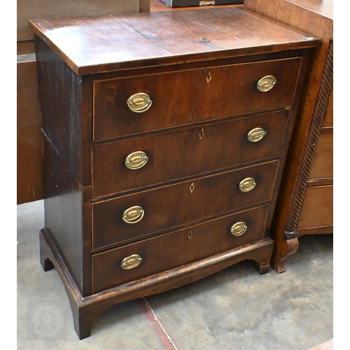 389 - A Georgian mahogany chest of four long drawers with oval brass handles, standing on shaped bracket f... 