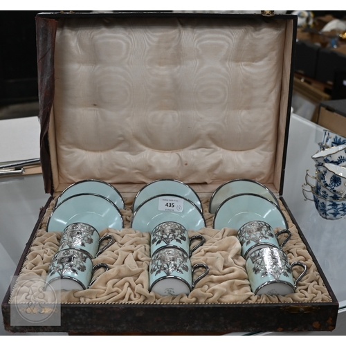 435 - A cased set of six Limoges coffee cans and saucers with silver overlays and a cased set of six Copel... 