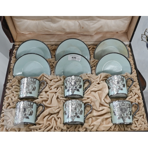 435 - A cased set of six Limoges coffee cans and saucers with silver overlays and a cased set of six Copel... 