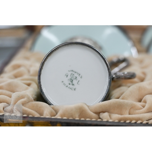 435 - A cased set of six Limoges coffee cans and saucers with silver overlays and a cased set of six Copel... 