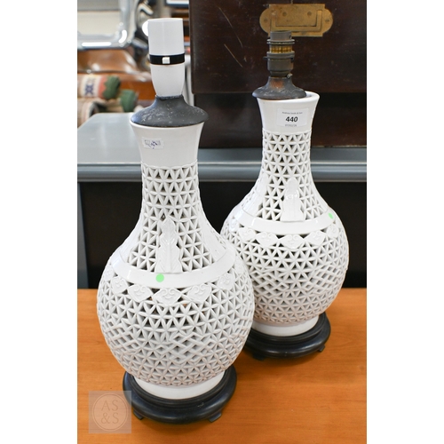 440 - A pair of Chinese white glazed reticulated pottery table lamps, 34 cm high (2)