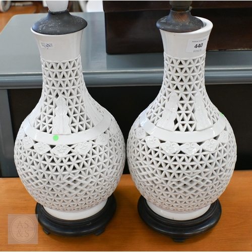 440 - A pair of Chinese white glazed reticulated pottery table lamps, 34 cm high (2)