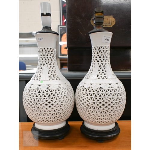 440 - A pair of Chinese white glazed reticulated pottery table lamps, 34 cm high (2)