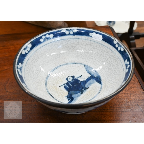 447A - A Chinese crackle-glazed bowl, painted with blue and white figures within burnt biscuit bands, 23 cm... 