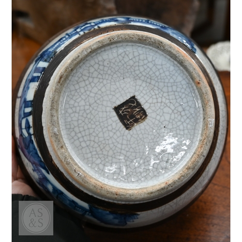 447A - A Chinese crackle-glazed bowl, painted with blue and white figures within burnt biscuit bands, 23 cm... 