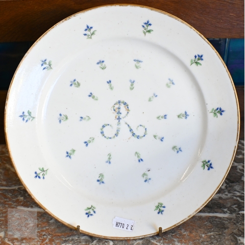 452 - An 18th century French Lille factory plate (ca 1790), painted with green and blue floral sprigs cent... 