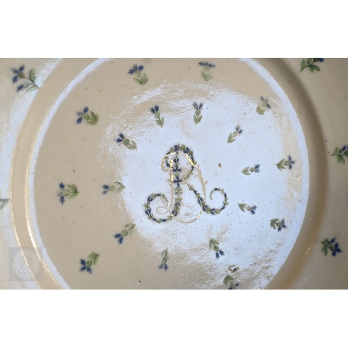 452 - An 18th century French Lille factory plate (ca 1790), painted with green and blue floral sprigs cent... 