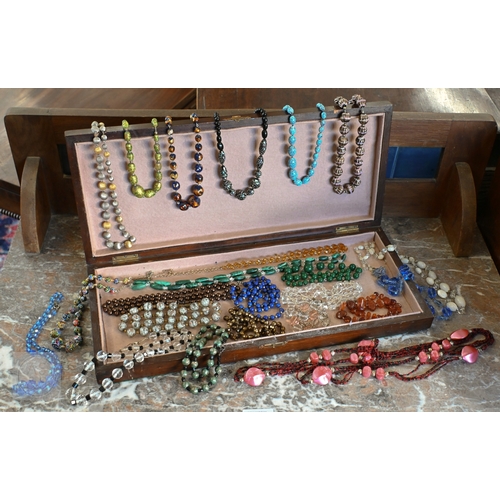454 - A selection of twenty three glass bead, stone and other costume jewellery necklaces, contained in a ... 