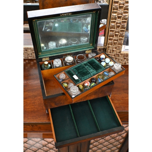 520 - A Victorian walnut toilet case with part fittings, marbles, etc