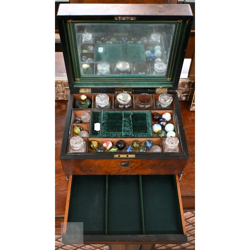 520 - A Victorian walnut toilet case with part fittings, marbles, etc