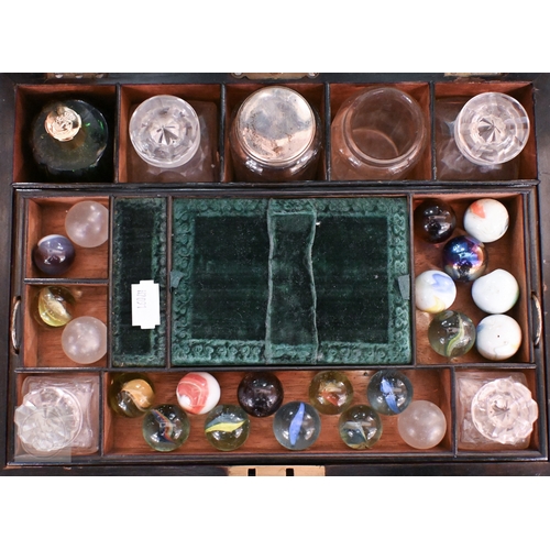 520 - A Victorian walnut toilet case with part fittings, marbles, etc