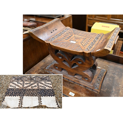 528 - An African carved wood stool with geometric patterned decoration, 39 x 53 cm, to/w a painted fibre p... 