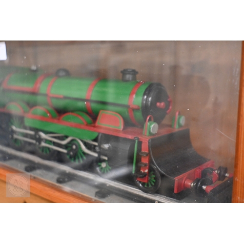 589 - A painted wood model train in glazed case, 67 cm long o/a