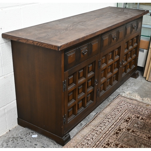 395 - A modern oak sideboard with three drawers and panelled cupboards in the antique manner