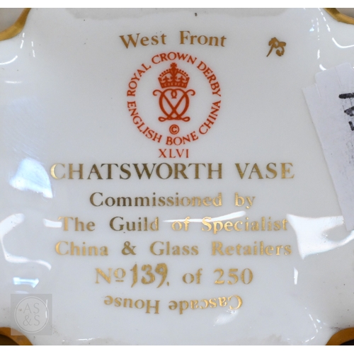 437 - A Royal Crown Derby china commemorative ewer, 'The Chatsworth Vase' painted with 'Cascade House' and... 