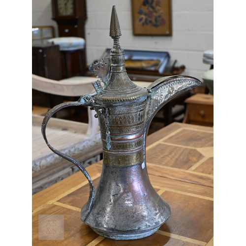 535 - A large Middle Eastern vintage copper and brass Dallah coffee pot with engraved decoration, 45 cm hi...