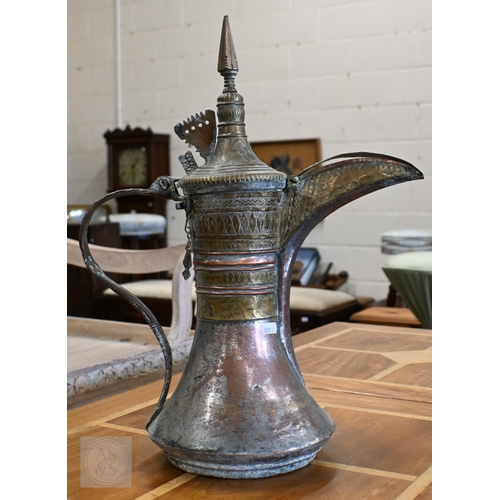 535 - A large Middle Eastern vintage copper and brass Dallah coffee pot with engraved decoration, 45 cm hi... 