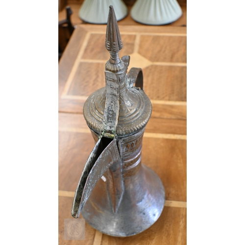 535 - A large Middle Eastern vintage copper and brass Dallah coffee pot with engraved decoration, 45 cm hi... 
