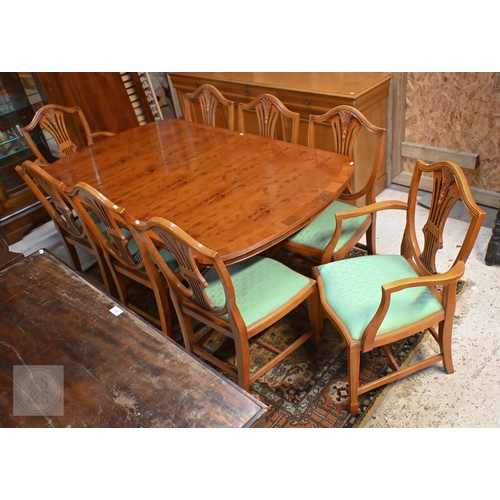 61 - # A Wade cross-banded yew veneer twin pedestal extending dining table, with two extra leaves, raised... 