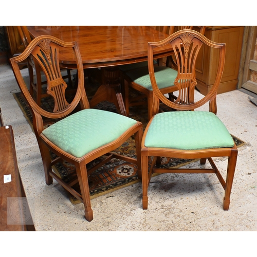 61 - # A Wade cross-banded yew veneer twin pedestal extending dining table, with two extra leaves, raised... 
