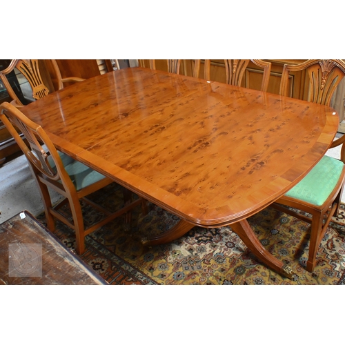 61 - # A Wade cross-banded yew veneer twin pedestal extending dining table, with two extra leaves, raised... 