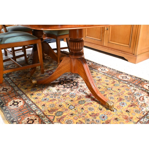 61 - # A Wade cross-banded yew veneer twin pedestal extending dining table, with two extra leaves, raised... 