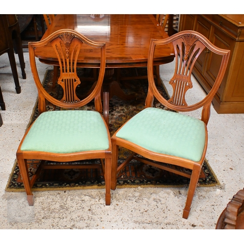 61 - # A Wade cross-banded yew veneer twin pedestal extending dining table, with two extra leaves, raised... 