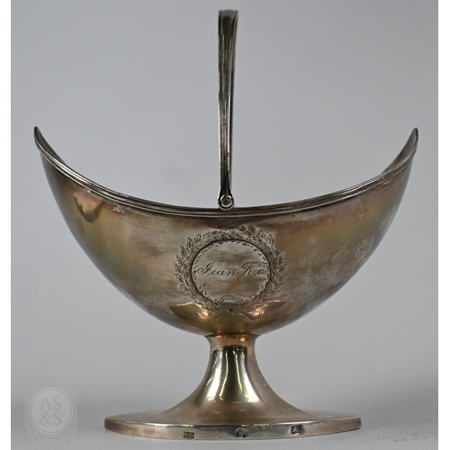 1 - A George III silver sugar basket of navette form, with swing handle and elliptical stemmed foot, mak... 