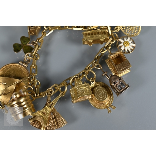 125 - An 18ct yellow gold rectangular linked curb bracelet with fifteen various charms attached including ... 