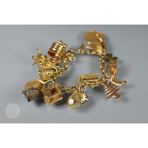 125 - An 18ct yellow gold rectangular linked curb bracelet with fifteen various charms attached including ... 