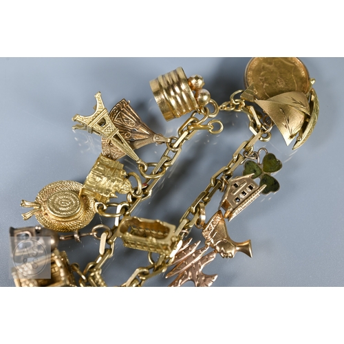 125 - An 18ct yellow gold rectangular linked curb bracelet with fifteen various charms attached including ... 