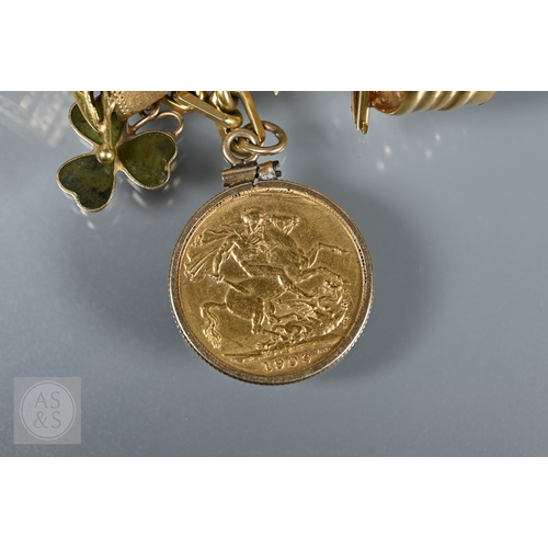 125 - An 18ct yellow gold rectangular linked curb bracelet with fifteen various charms attached including ... 