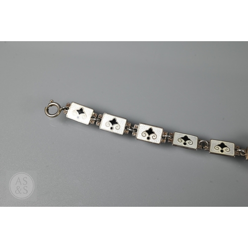 126 - A Norwegian enamel and white metal bracelet formed of eight enamelled plaques featuring Nordic scene... 