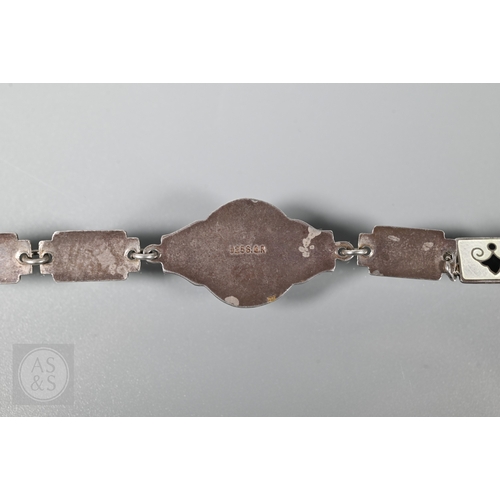 126 - A Norwegian enamel and white metal bracelet formed of eight enamelled plaques featuring Nordic scene... 