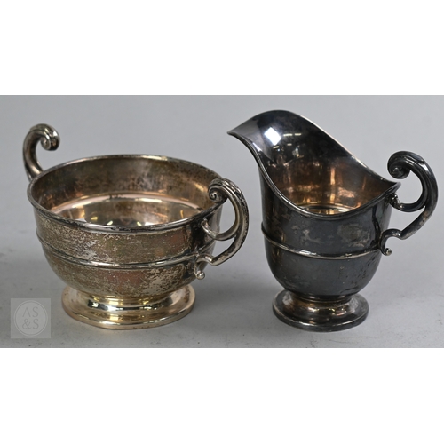 27 - An Edwardian silver three piece bachelor tea service of Empire form with composite handle and finial... 