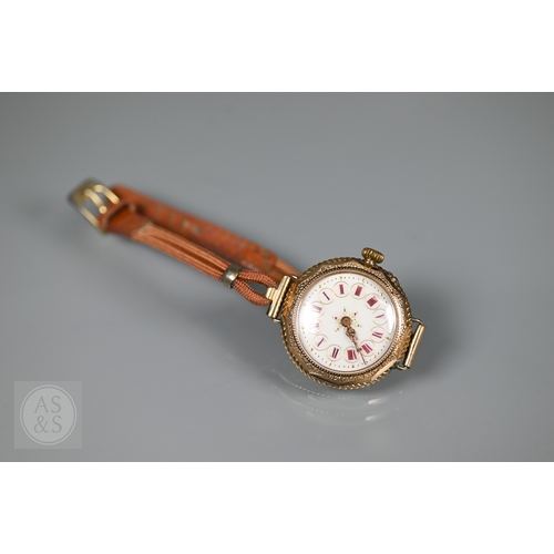 295 - A vintage Swiss ladies 14K wristwatch, the white dial enamelled with Roman numerals and gilt decorat... 