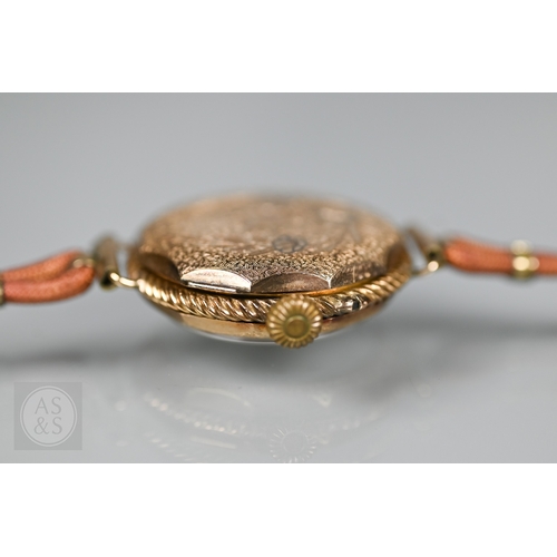 295 - A vintage Swiss ladies 14K wristwatch, the white dial enamelled with Roman numerals and gilt decorat... 