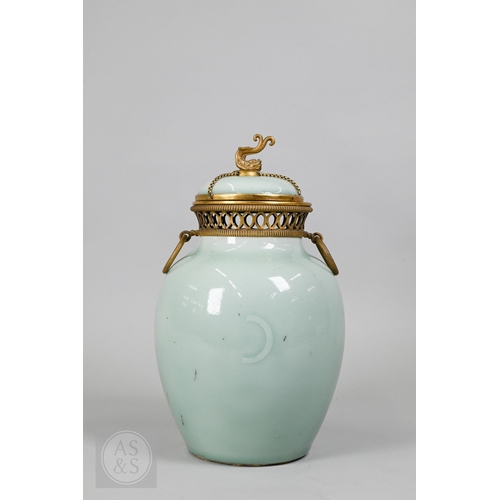 311 - An 18th century Chinese celadon jar and cover,&nbsp;Yueyaer guan&nbsp;(月牙耳罐) with gilt metal mounts, the taper...