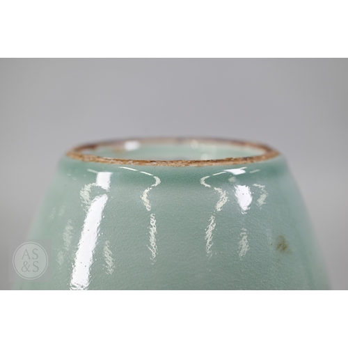 311 - An 18th century Chinese celadon jar and cover, Yueyaer guan (月牙耳罐) with gilt metal mounts, the taper... 