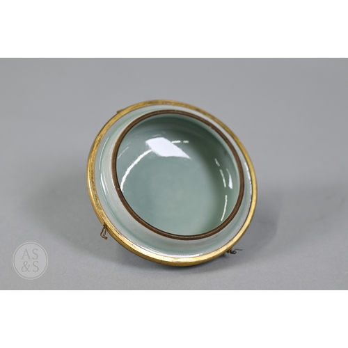 311 - An 18th century Chinese celadon jar and cover, Yueyaer guan (月牙耳罐) with gilt metal mounts, the taper... 