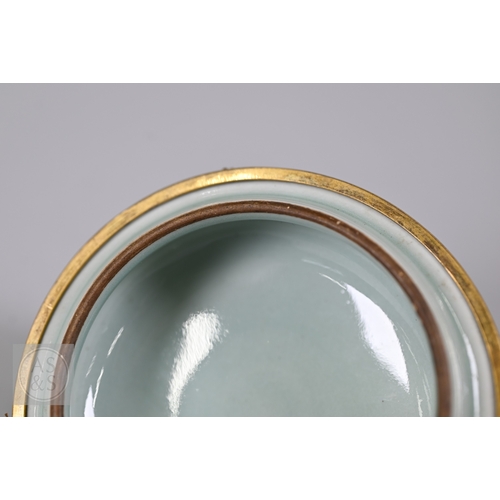 311 - An 18th century Chinese celadon jar and cover, Yueyaer guan (月牙耳罐) with gilt metal mounts, the taper... 