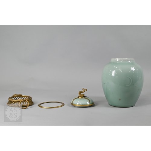311 - An 18th century Chinese celadon jar and cover, Yueyaer guan (月牙耳罐) with gilt metal mounts, the taper... 