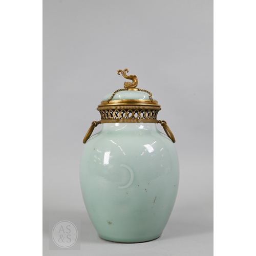 311 - An 18th century Chinese celadon jar and cover, Yueyaer guan (月牙耳罐) with gilt metal mounts, the taper... 